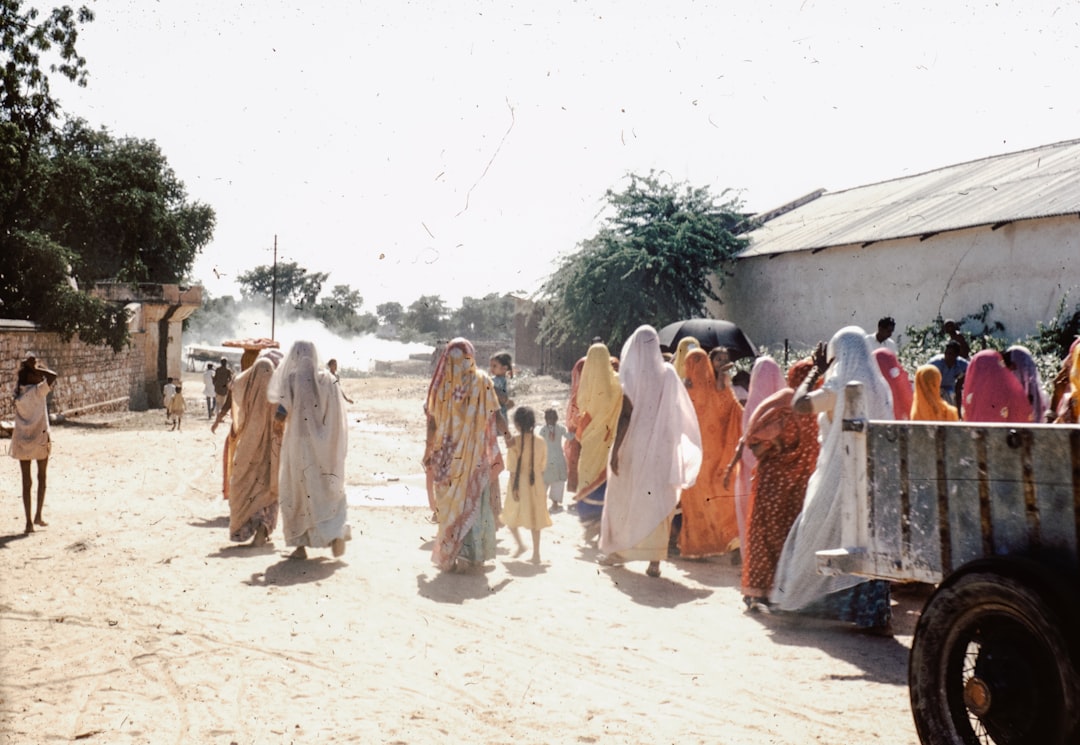 group of women walking on a dirt road