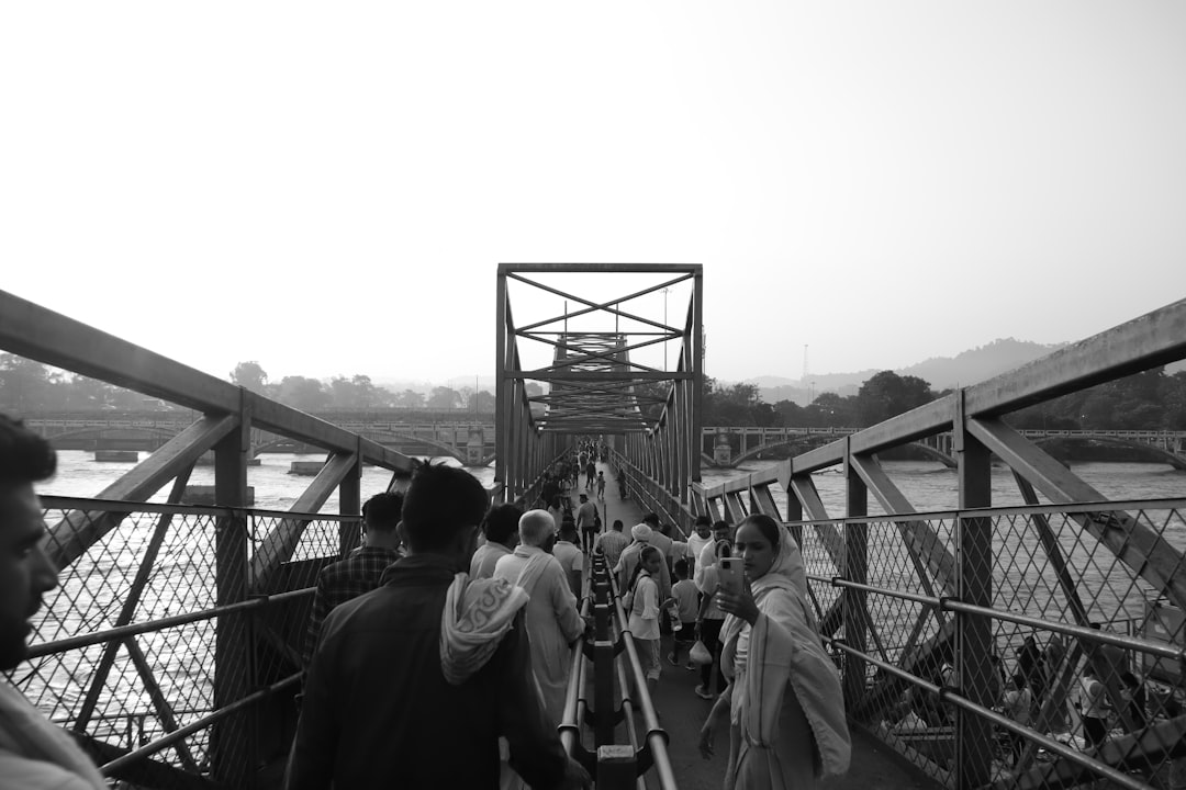 group of people walking across a bridge India