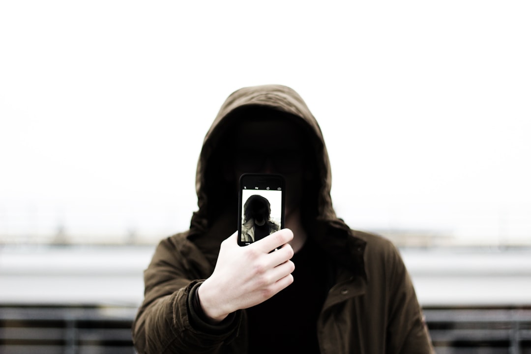 man wearing black hooded jacket representing cybersecurity threat