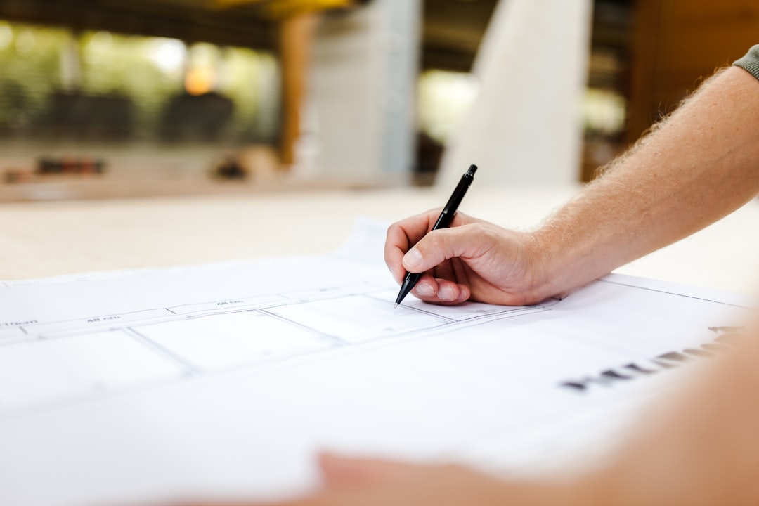 person writing on white paper representing planning strategy