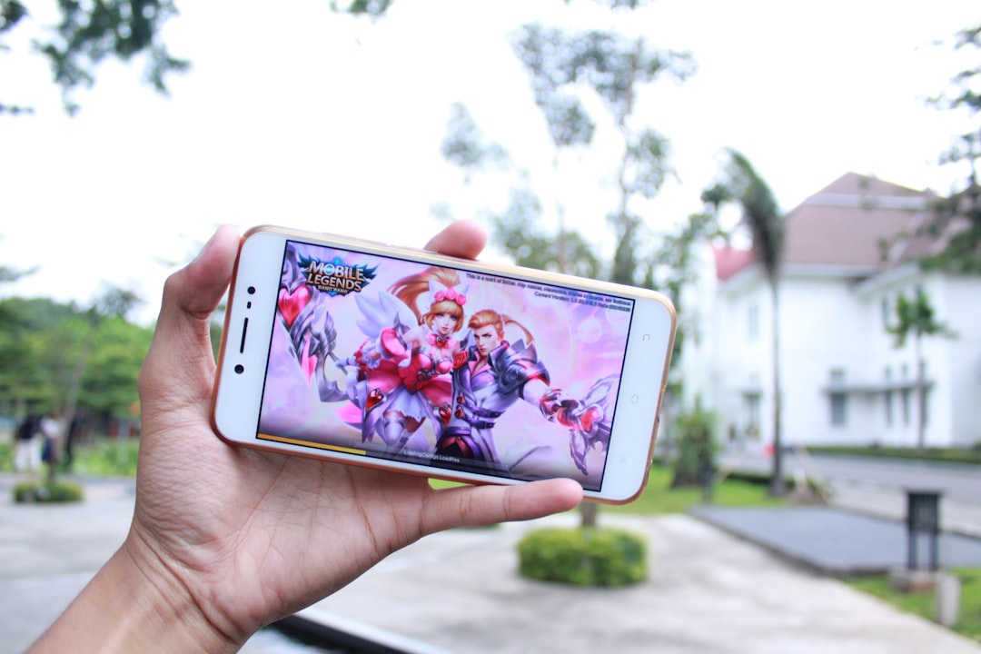 person holding white iphone 5 c