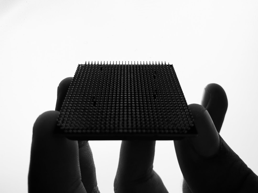 a person holding up a piece of electronic equipment