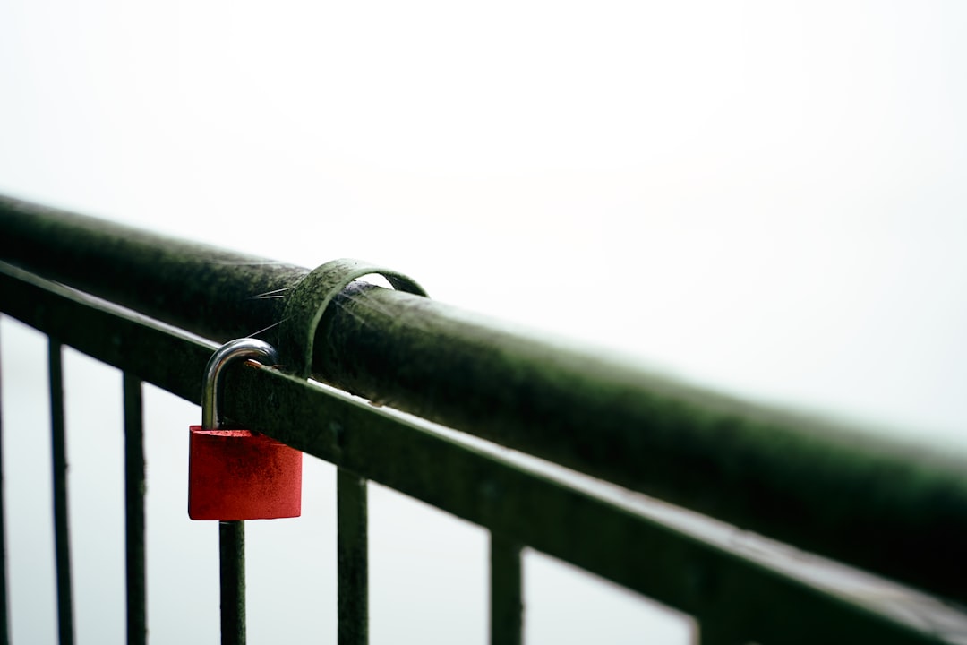 red padlock on black metal railing