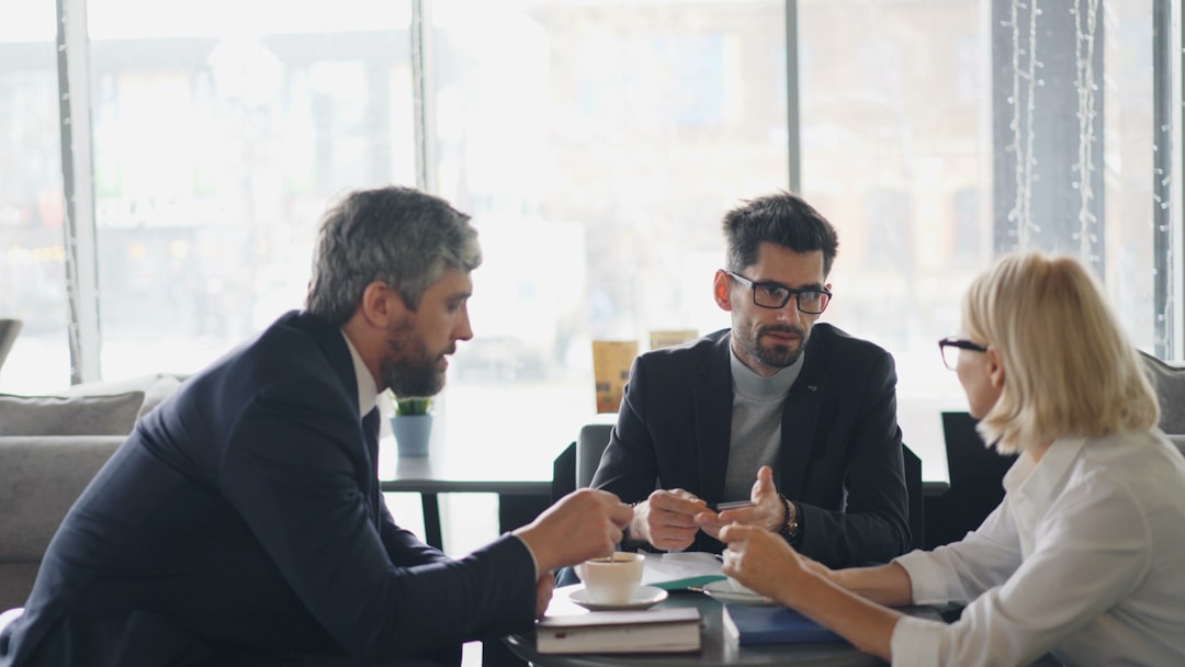 a group of people sitting around a table talking