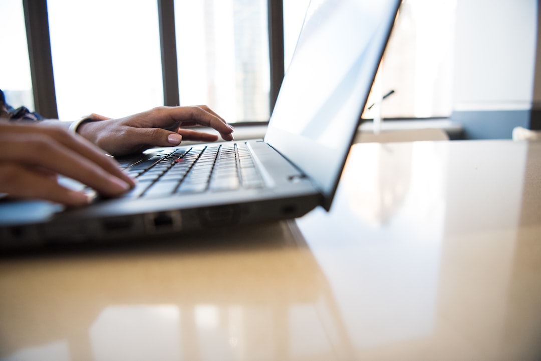 person typing on laptop keyboard