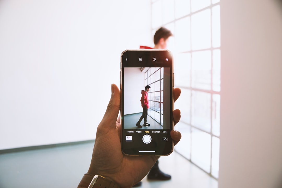person taking a photo of man