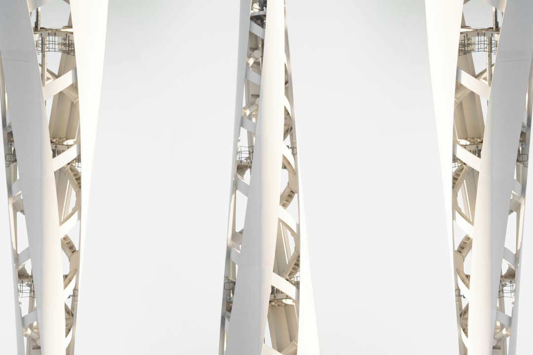 a tall white structure with a clock on it's side