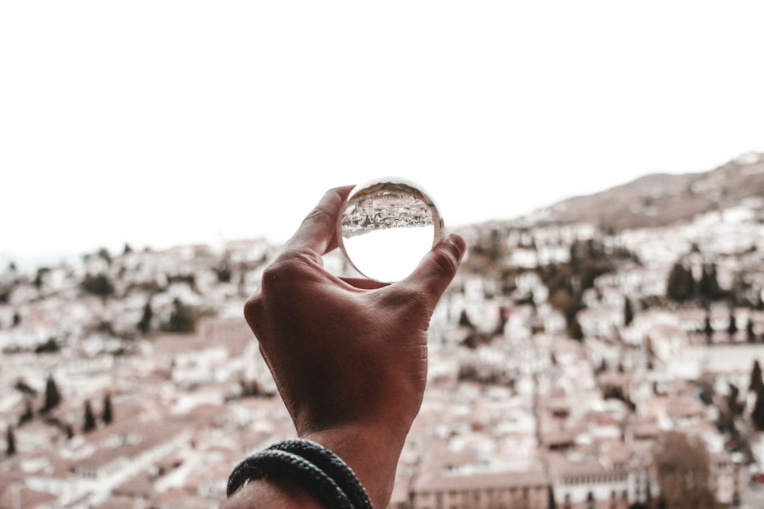 person holding glass ball