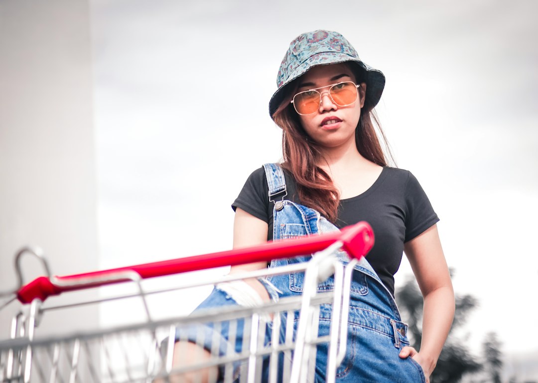 woman stepping on shopping cart